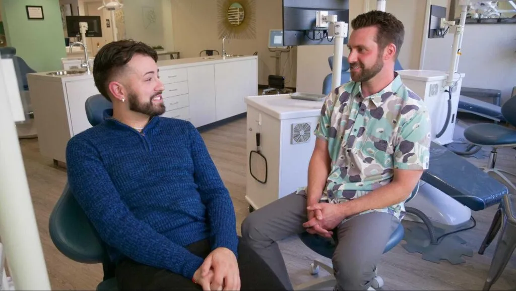 Dr. Andrew J. Leland talk with a happy client