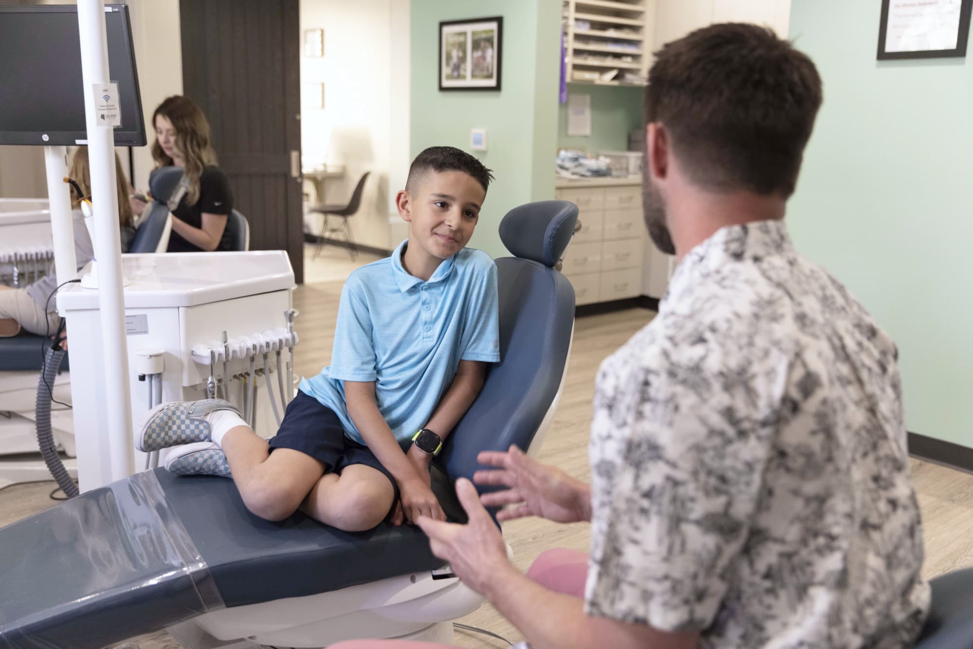 Dr. Andrew J. Leland talk with a boy