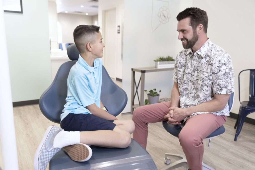 Dr. Andrew J. Leland talk with a boy